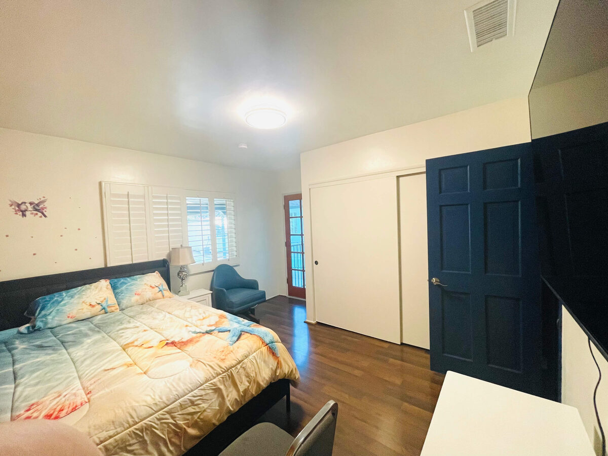 Bedroom with patio and garden views